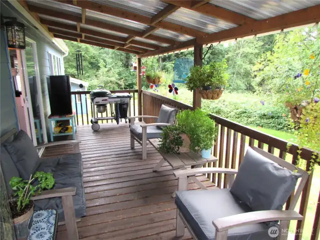 As you approach covered deck overlooking open grounds area to East & South.
