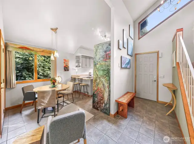 Surrounded by windows and elevated ceilings, the dining space feels airy and intimate, perfect for casual meals or entertaining.