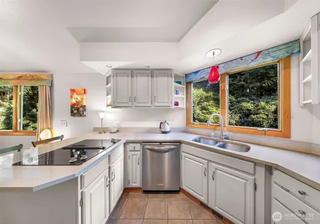 Prepare meals while soaking in serene views, thanks to large windows over the sink.