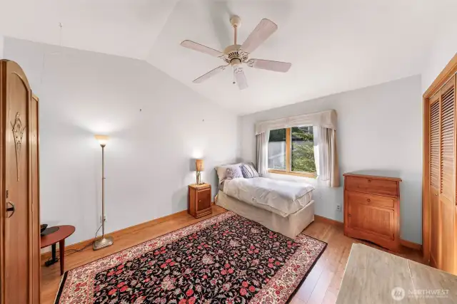 The second bedroom features warm wood floors.