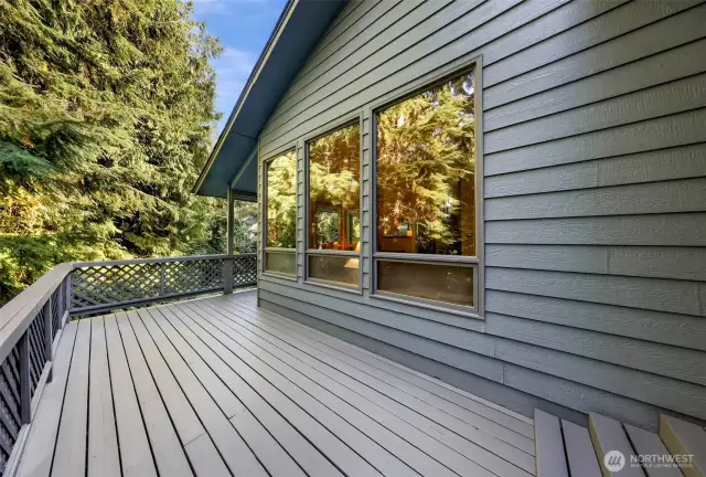 This uncovered section of the deck captures sunlight throughout the day, a perfect spot for container gardening or lounging.
