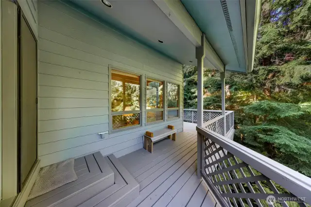From this cozy covered entry, the deck expands around the home, connecting multiple indoor spaces to the outdoors.