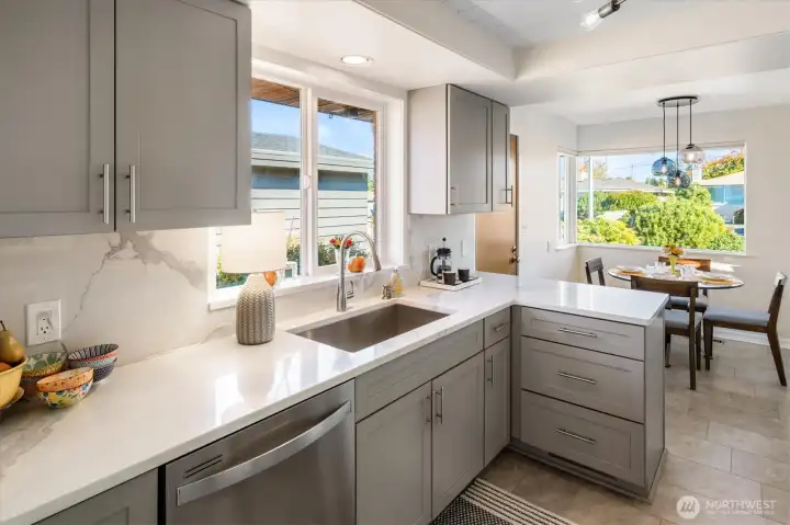 The layout features a charming dining nook in the kitchen overlooking the garden.