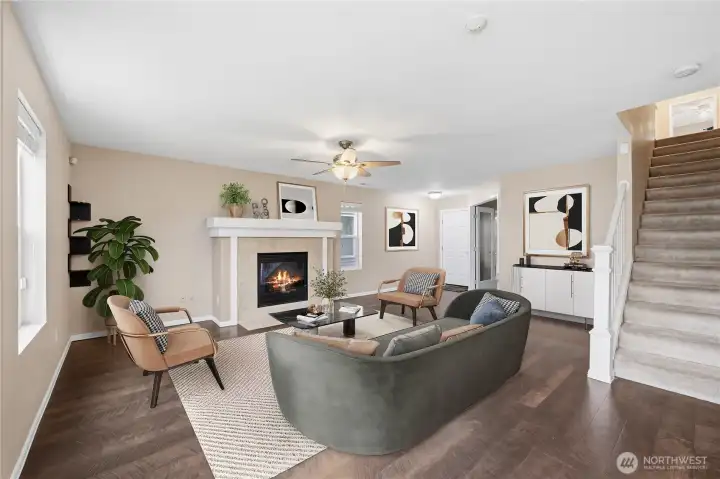 Spacious living room centered around a cozy fireplace.