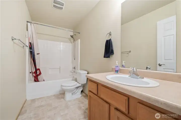 Full bath with tub/shower combo.