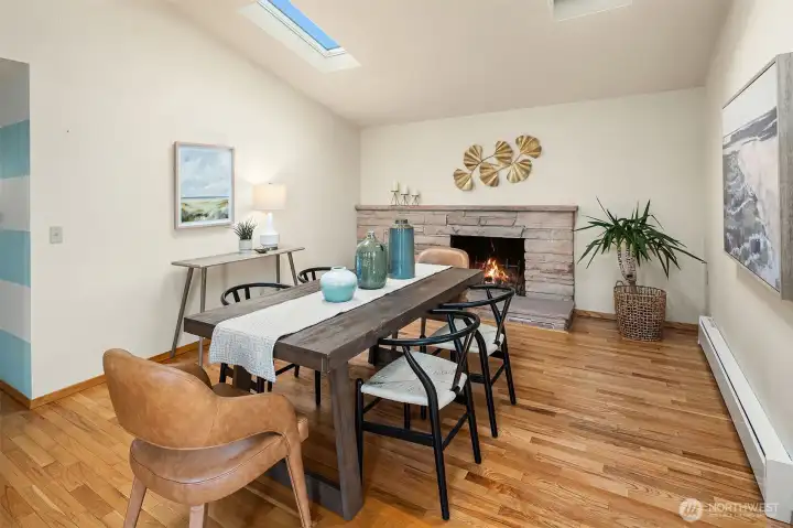 Dining or other flexible area with fireplace and sky lights off the kitchen.