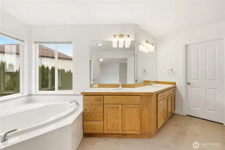 Spa-inspired primary bath with soaking tub and dual vanity