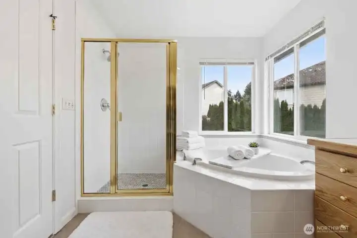 5-piece primary bathroom suite with shower and soaking tub