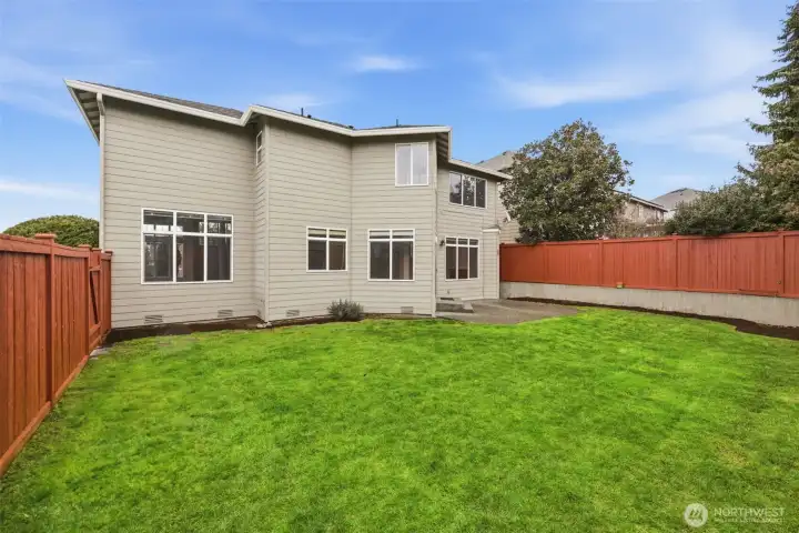 Private fully fenced backyard with flat lawn and space to play or entertain