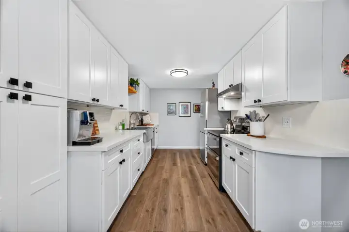 Floor to ceiling pantry storage. Gorgeous ALL  new cabinets, LVP flooring, quartz counters and S/S appliances.