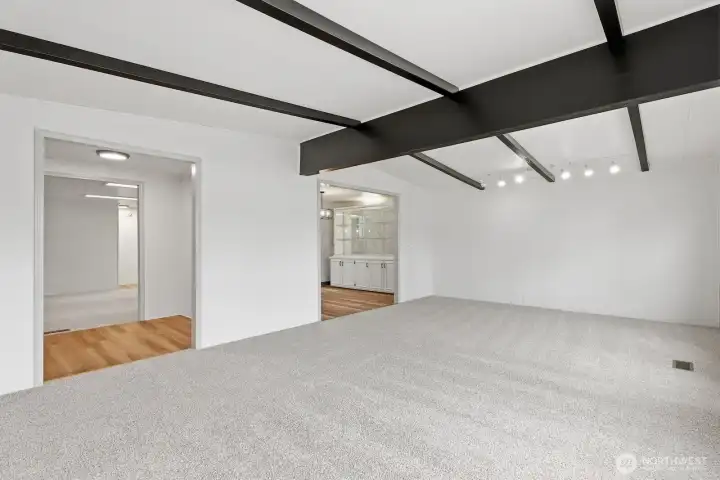 Large family room with lots of natural light and vaulted ceilings