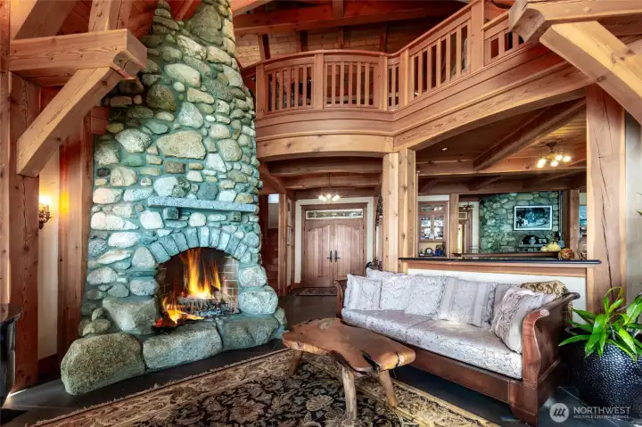 Living room fire with island field stones, opens to upstairs study