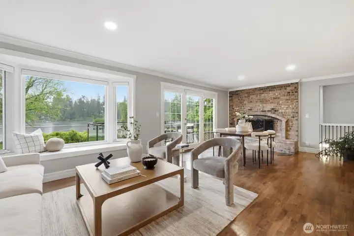 Open concept living area with views of the lake and lush landscaping.