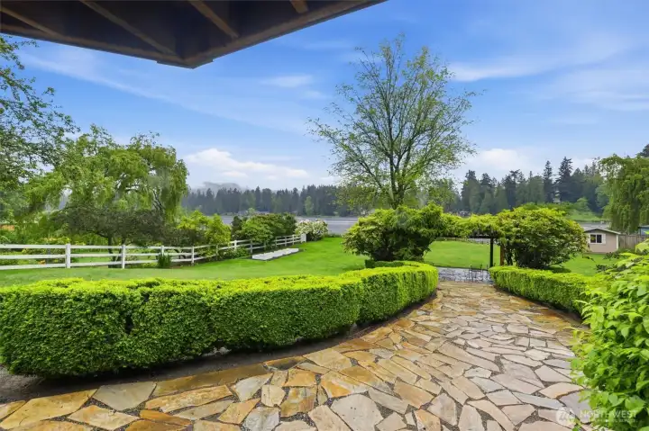 Sandstone pavers lead to a incredible lakeside Wisteria canopy....