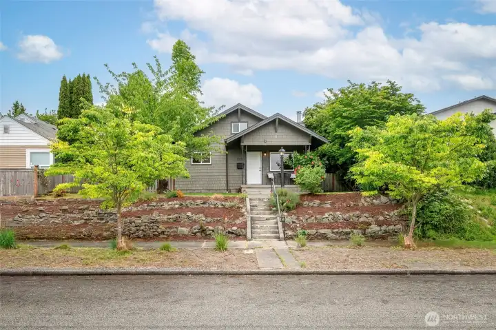 Perched above a beautifully landscaped front yard