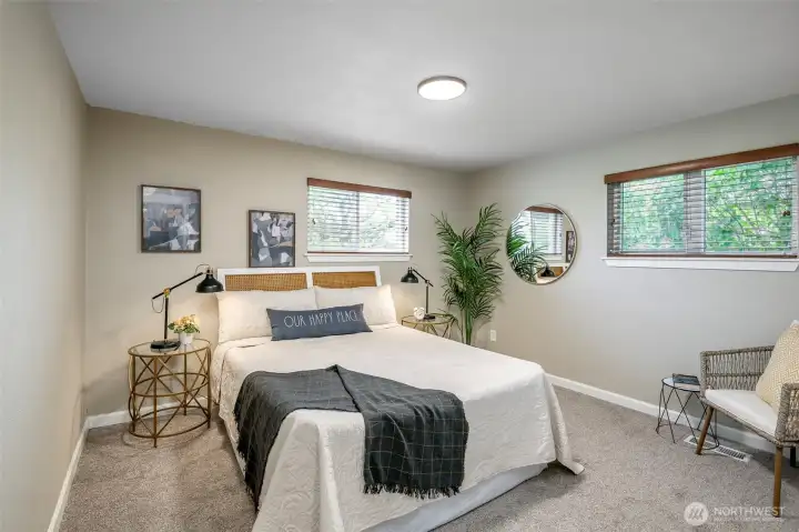 Bedroom 1 overlooks the street (west) and north, side yard lilacs.