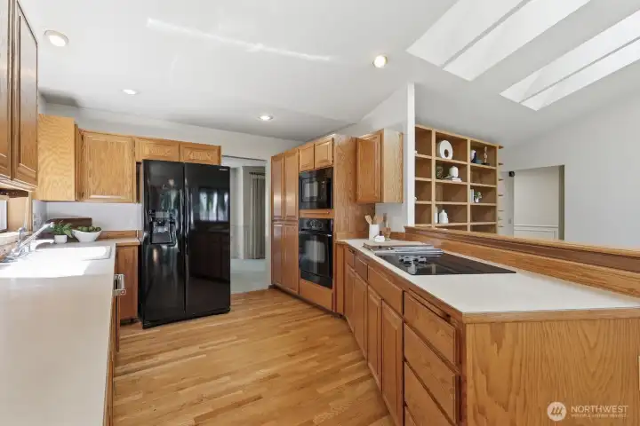 Another view of the kitchen with hardwood floors