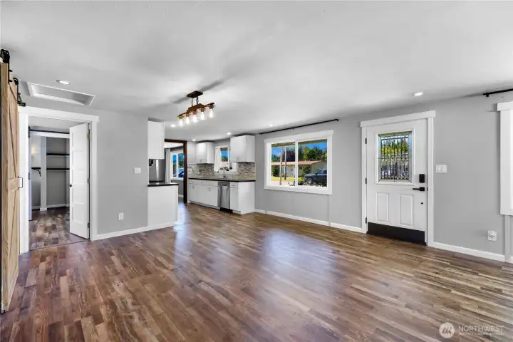 Main living area looking to kitchen and primary bedroom
