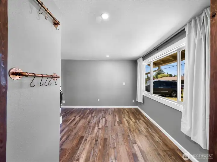 Located through kitchen is this great additional space that is used as utility with washer and dryer but could easy be converted into office space or hobby space