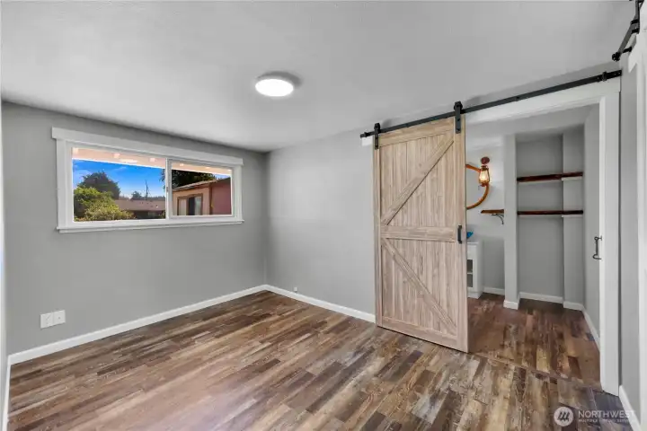 Primary bedroom located off the main living space with bath attached