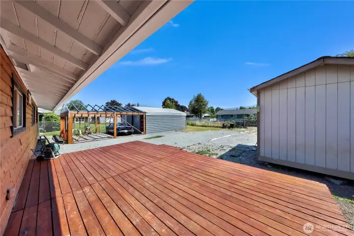 Large deck located off the backside of home accessible through utility/bonus room.