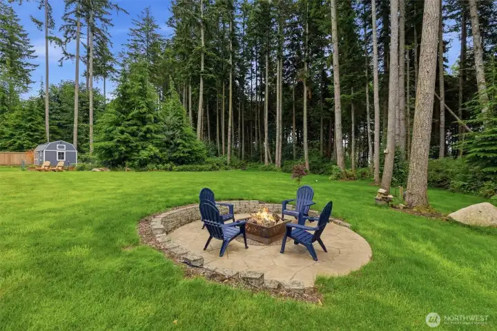 Fire pit in the yard, surrounded by trees. It doesn't get any more peaceful than this! Fire pit in the yard, surrounded by trees. It doesn't get any more peaceful than this!