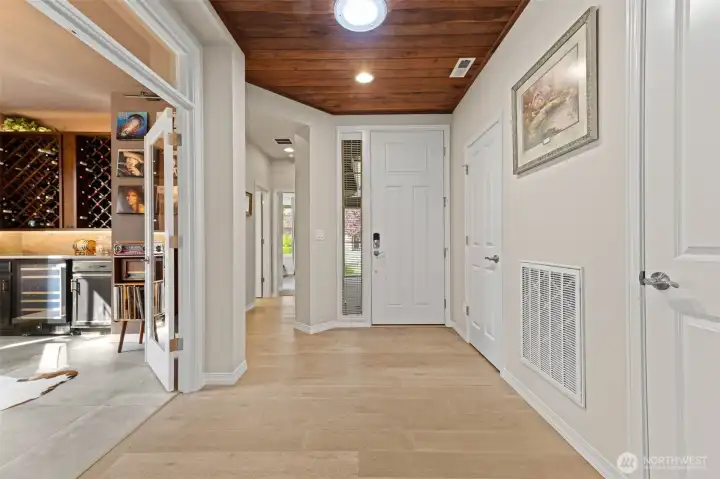 front entry with guest bed, bath, and den