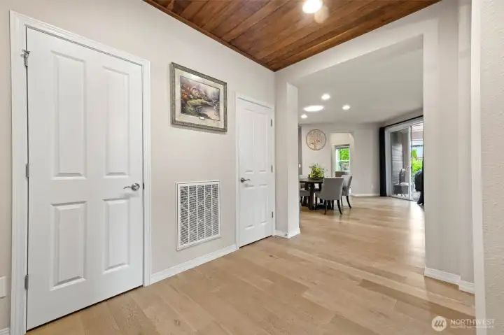 storage closet with auto lighting and walnut accents
