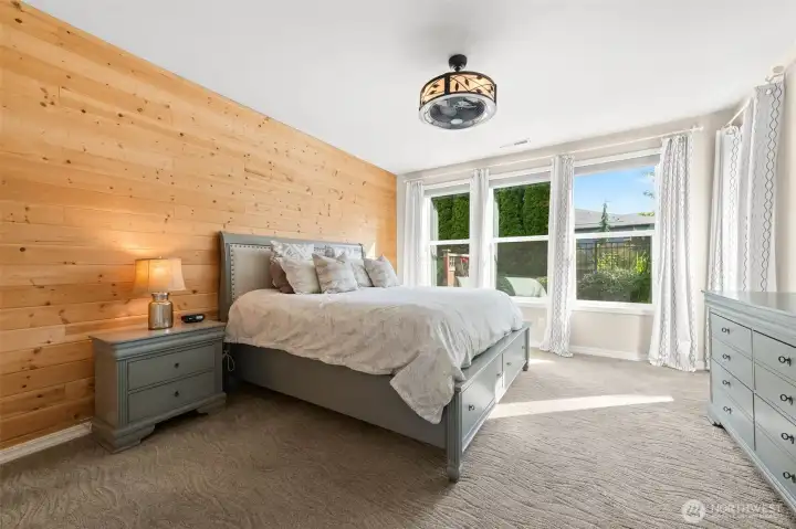 Huge accent wall with 4 picture windows that include room darkening shades