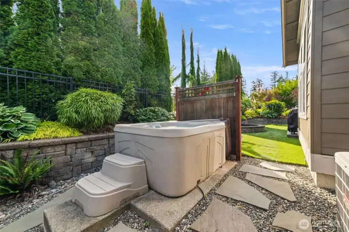 hot tub conveys and feels secluded in the back yard
