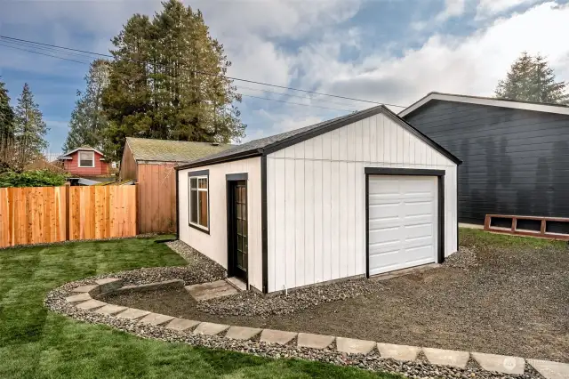 Extra-wide detached 1-car garage with an automatic garage door opener that has room for an extra storage area/work space.