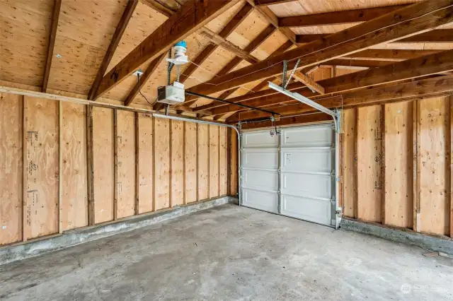 Look at all this space that is ready for you to park your car in and work on projects too. It has an automatic garage opener and power and lights out here.