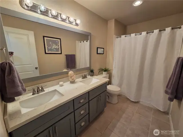 Lovely Main Bath w/dual sinks, granite counter and tile flooring