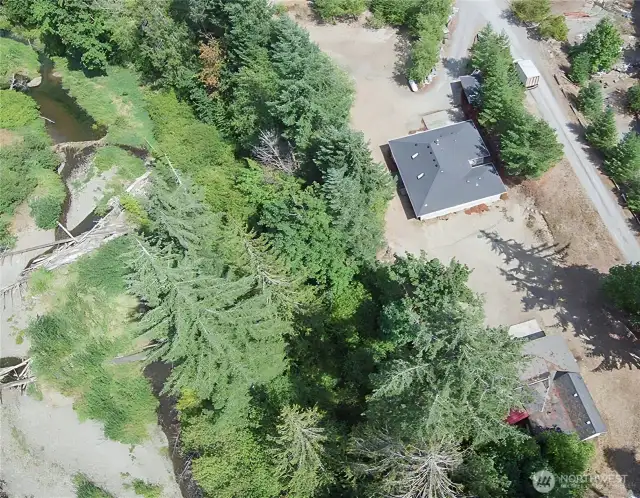 Aerial photo of the property. The house top shop-building bottom and creek to the left.