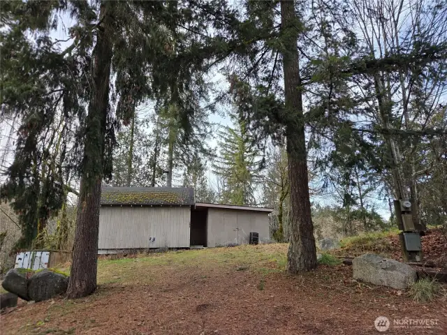 1000 sqft building - Shop that needs your vision. Has it's own driveway access, power box and yes property ends right at Shipping container is on this property and is the end of property line.