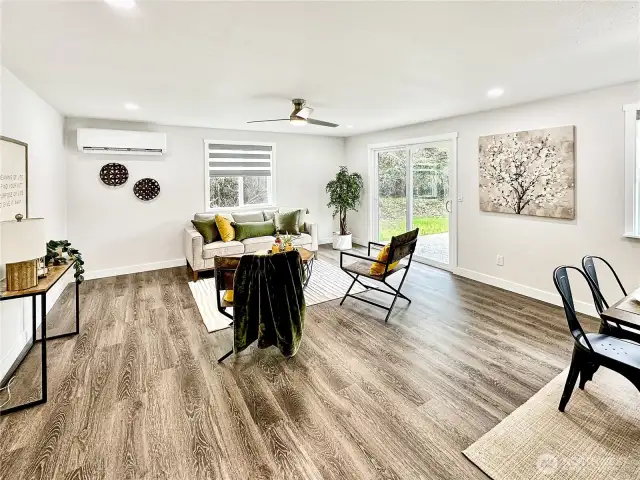 View of great room from dining area.  Ductless mini split offers cooling in warm temperatures.