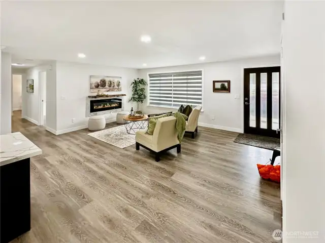 View of living room and entry.  Lovely laminate flooring throughout.