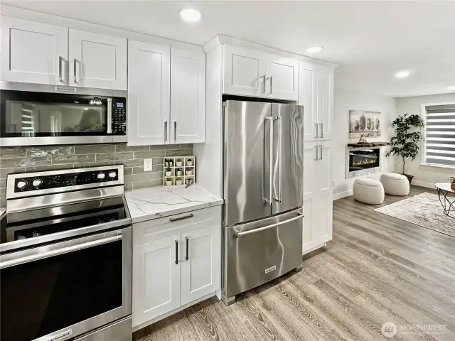 Kitchen features large pantry cabinet and stainless appliances.