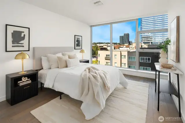 Spacious Primary Bedroom with floor to ceiling windows