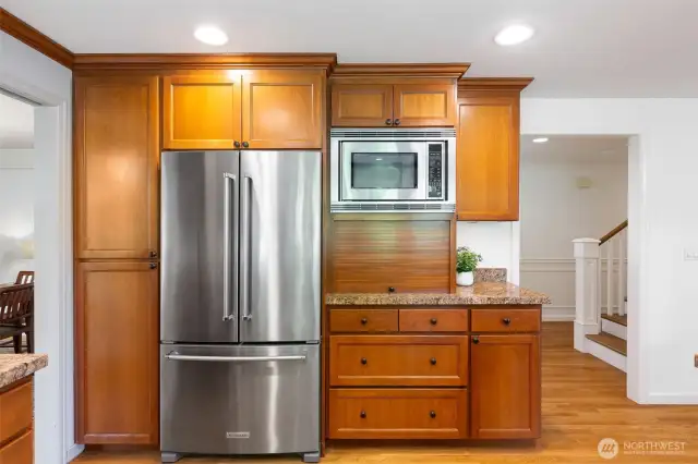 Open kitchen with stainless steel appliances and thick stone countertops