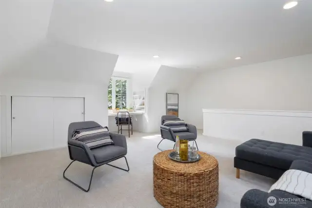 Spacious upstairs bonus/recreation room with skylight and built ins. Located above the garage.