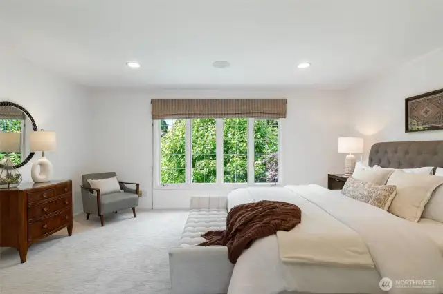 The primary bedroom overlooking the backyard