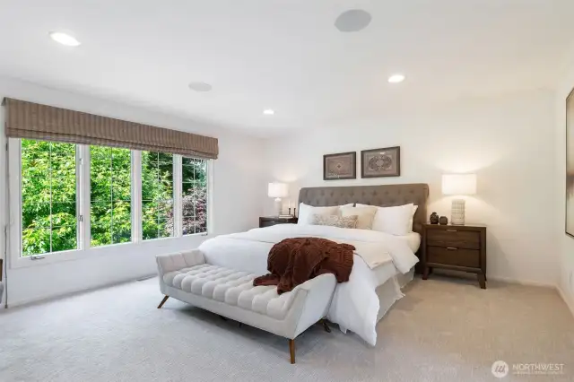 The primary bedroom overlooking the backyard