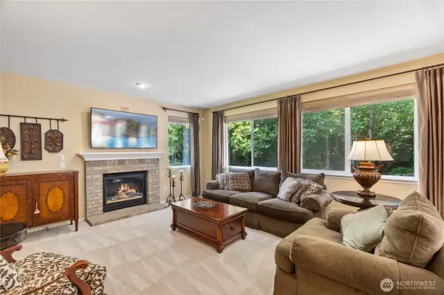 Over-stuffed couches, a cozy gas fireplace and wall of windows that connect you to the out of doors is where everyone will want to put their feet up.