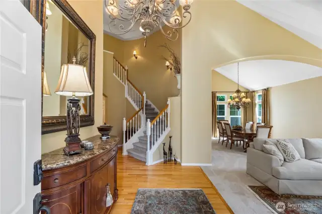 As the front door swings open you are immediately greeted by a grand foyer with a sweeping staircase, gleaming hardwood floors and vaulted ceilings which all add to a sense of graciousness.