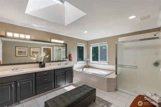 The updated primary bath is filled with natural light, offers new flooring, dual sinks and a deep soaking tub.