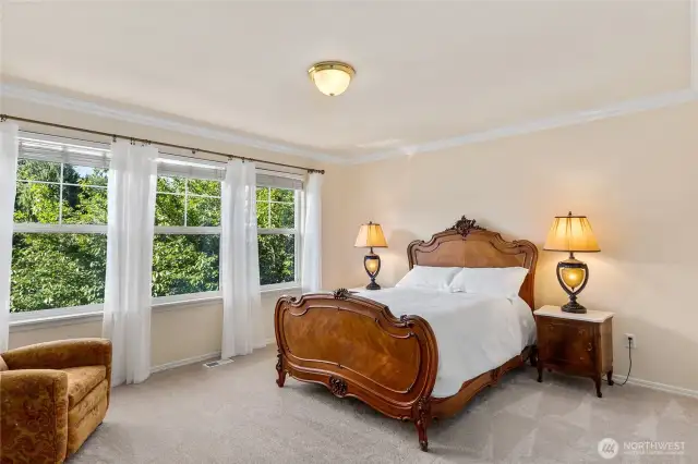One of two additional upstairs guest rooms welcomes visitors in a light and airy space.