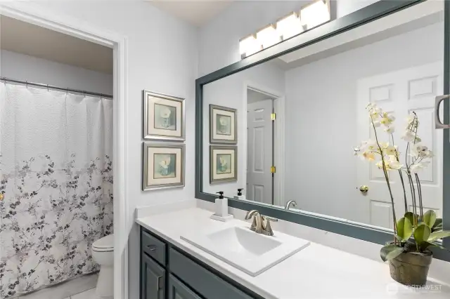The main upstairs bath has also been refreshed with new flooring and light fixtures.