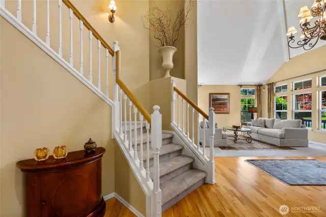 The living room is just to the right of the foyer and has tall windows that frame views of the front yard.