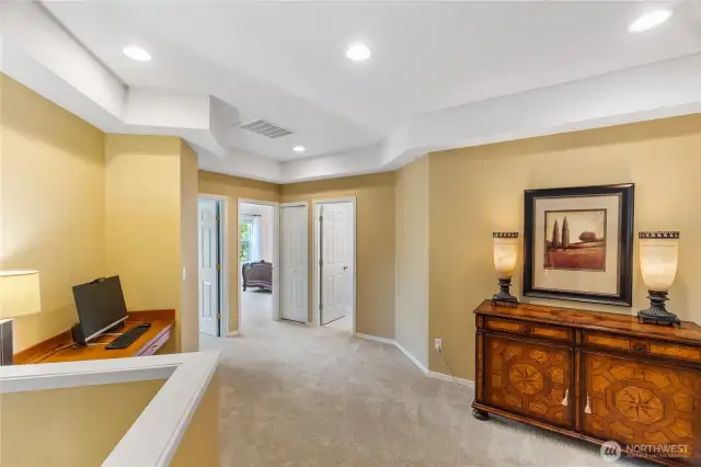 The upstairs landing provides an alcove for additional desk/study space.  The two generously sized guest rooms are to the left and the guest bath is the door on the right.  The primary suite is to the right of this view.